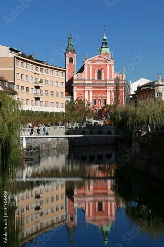 Picturesque building around the Ljubljanica River in central Ljubljana, Slovenia. Franciscan Church of the Annunciation in the middle. Autumn in Ljubljana.