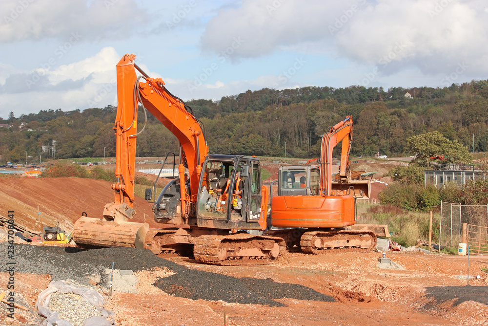 Diggers on a road construction site Diggers on a road construction site