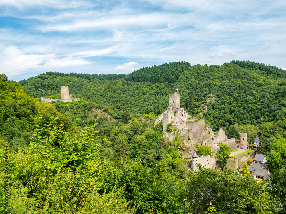 Summer panoramic view to the ruins of Oberburg and Niederburg, the Upper and Lower Castle of Manderscheid, Germany as seen from the main street