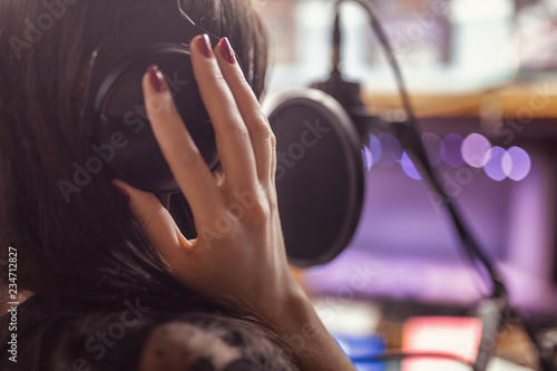beautiful girl records a song in a professional Studio photo