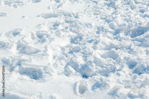 Traces of people, animals and birds in the fresh white snow. Fresh snow fell. Snow texture for winter background.