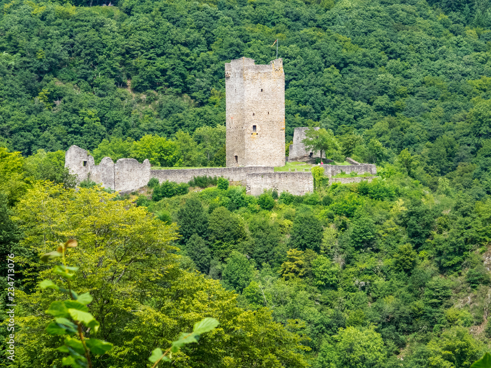 Summer view to the ruins of Oberburg or Upper Castle in Manderscheid, Germany as seen from the main street Summer view to the ruins of Oberburg or Upper Castle in Manderscheid, Germany as seen from the main street