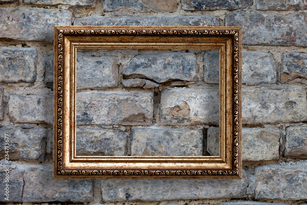 Golden frame on brick wall background. Empty place for your picture