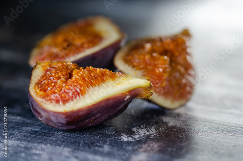 Figs on a dark wood background. selective focus on the figs slice