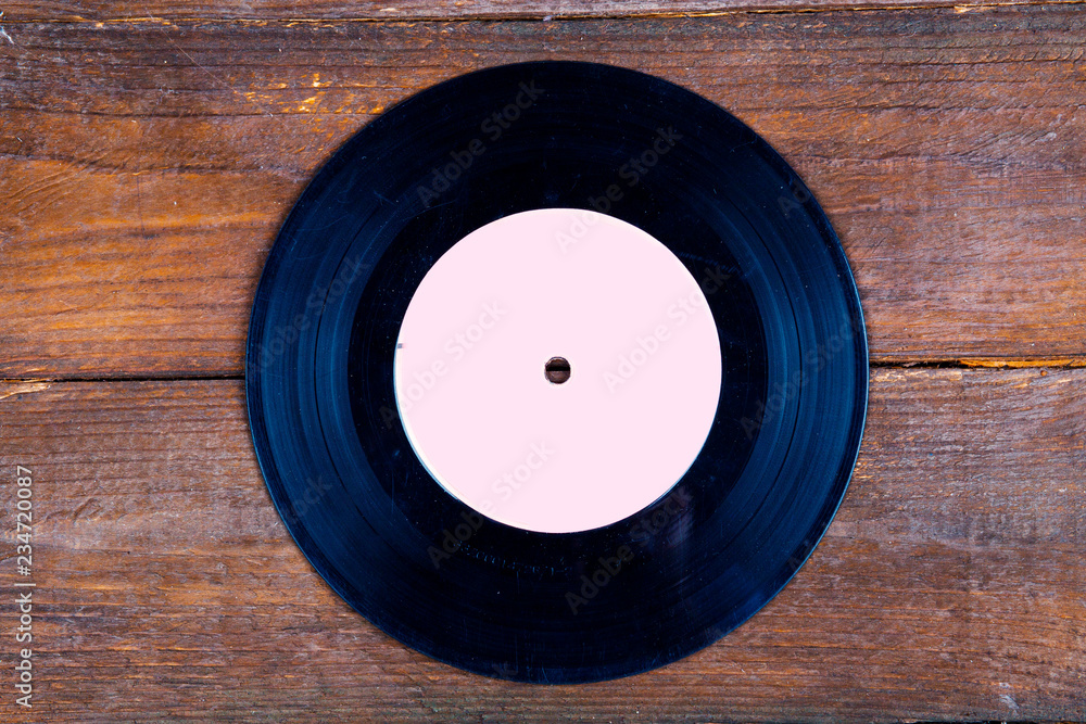 Vinyl record on wooden background Vinyl record on wooden background