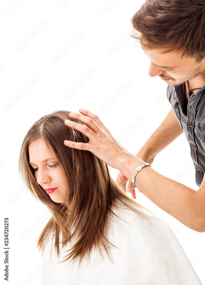 Fototapeta premium Professional hairdresser with long hair model, isolated on white