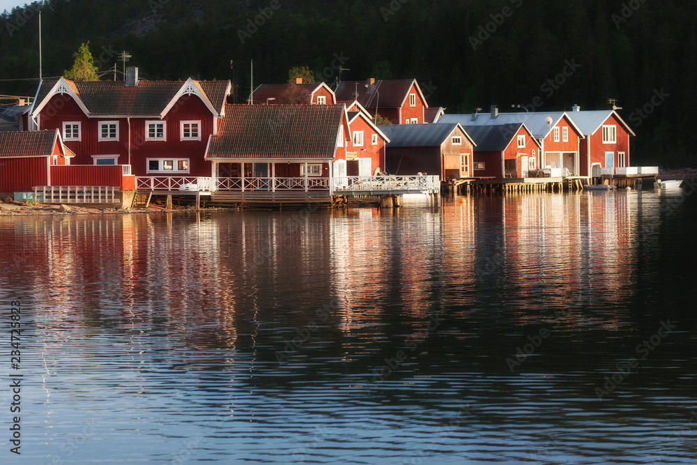 Fototapeta premium red houses at sunset in the fishing village of Norfaellsviken, Höga Kusten, Sweden