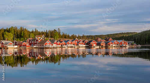 red houses at sunset in the  fishing village of Norfaellsviken, Höga Kusten, Sweden photo