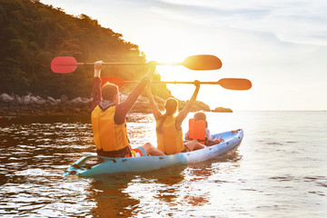 Happy family kayak walking sunset sea island