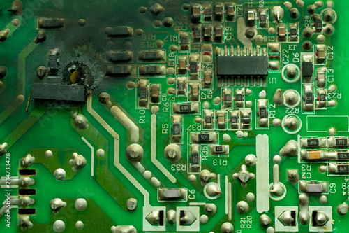 burnt electronics board, with black soot on the surface