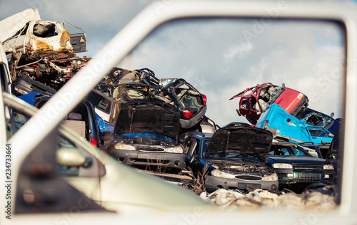 pile of old used cars waiting to be disposed on scrapyard