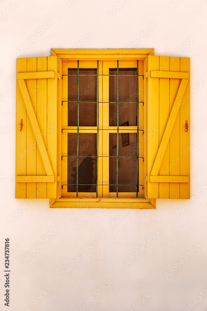 Obraz premium Window with colored shutters in the old house
