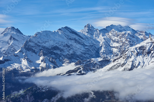 Winter mountain snowy peaks over the clouds in the Lauterbrunnen valley. Jungfrau region in Switzerland. © thecolorpixels
