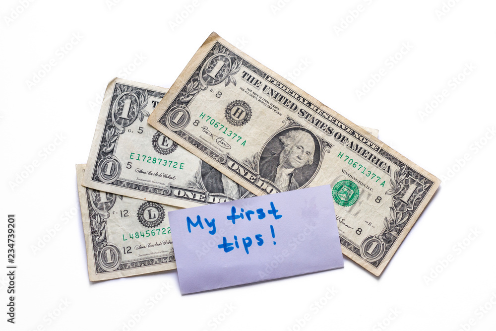 Banknotes of 1 american dollar isolated on white background. Experience in waiter work. Tips in restaurant. Copy space for text Banknotes of 1 american dollar isolated on white background. Experience in waiter work. Tips in restaurant. Copy space for text