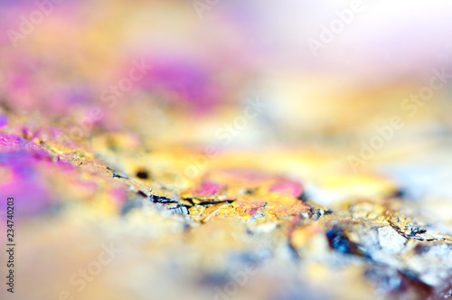 Beautiful colorful background of thin layer of titanium on the surface of quartz. Macro photo