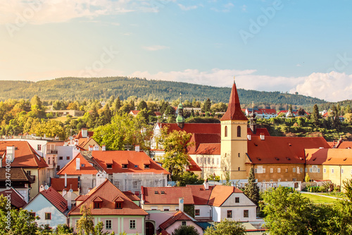 Cesky Krumlov, UNESCO, Czech Republic. Sunset aerial view of the old town architecture with red rooftops and houses.