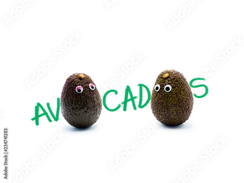 Romantic avocados couple with googly eyes as man and woman, funny food concept for creative projects