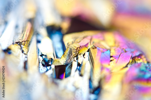 Beautiful colorful background of thin layer of titanium on the surface of quartz. Macro photo