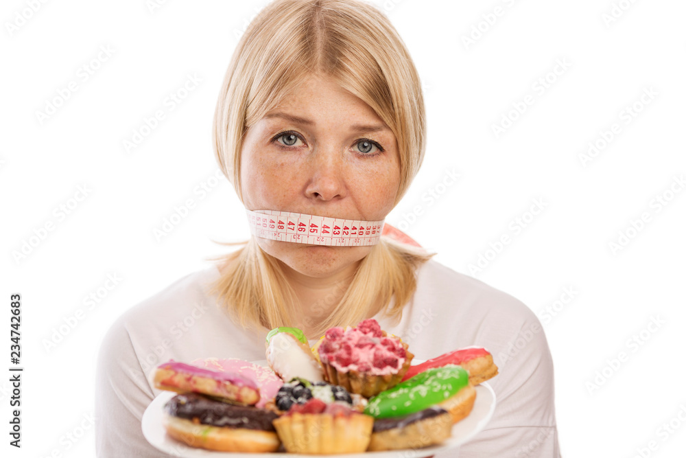 Young woman with a plate of cakes Young woman with a plate of cakes