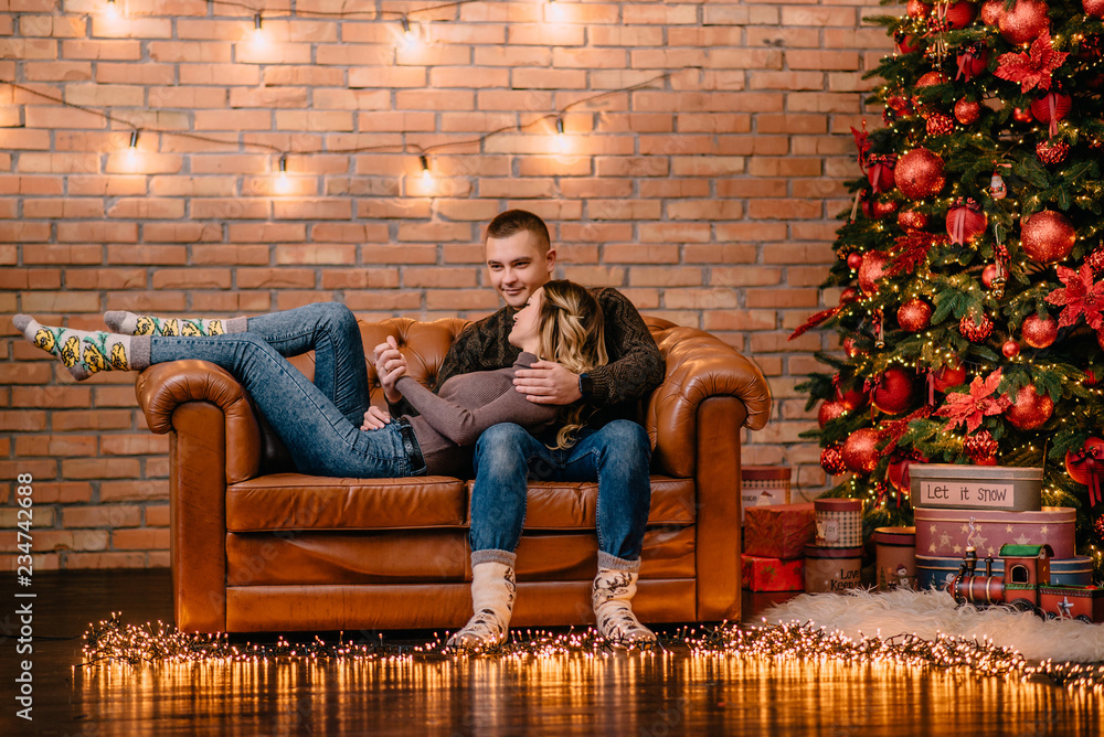 Obraz premium loving couple cuddling on couch at home