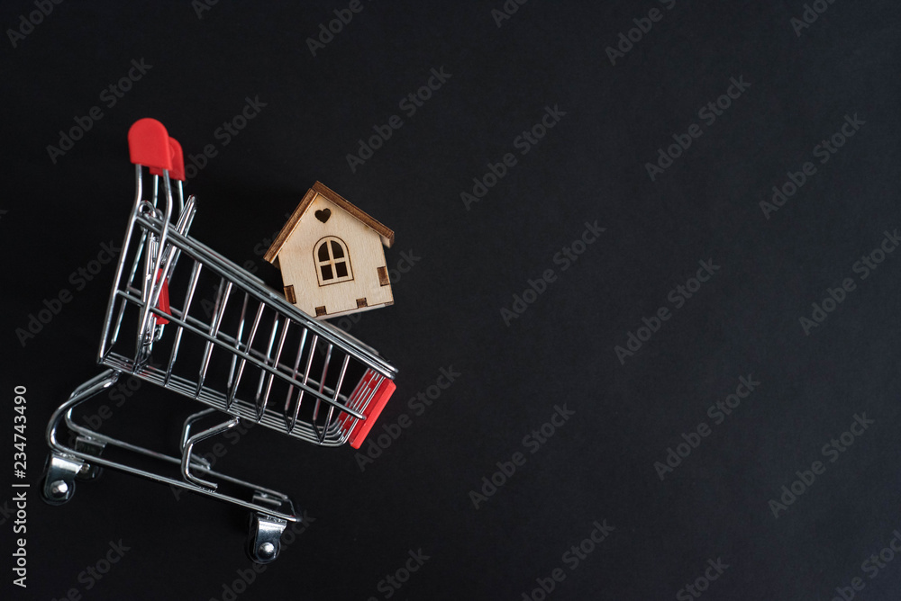 Buying a house, building repair and mortgage concept. Estimation real estate property with loan money and banking with shopping cart on black background