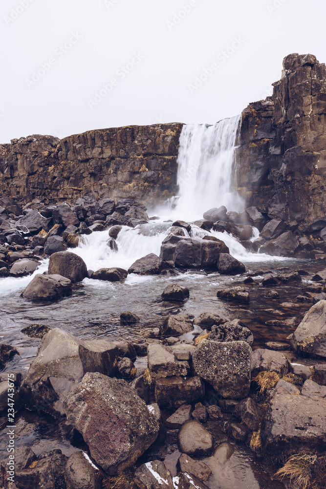 Waterfall between stone hills Waterfall between stone hills