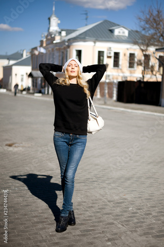 Street fashion look. Beautiful girl in black hoody photo