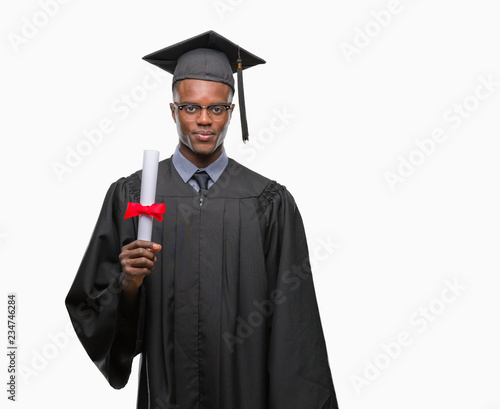 Young graduated african american man holding degree over isolated background with a confident expression on smart face thinking serious
