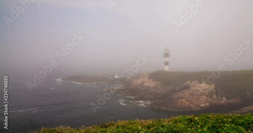 Timelapse of misty day at Ribadeo Lighthouse, Galicia, Spain photo