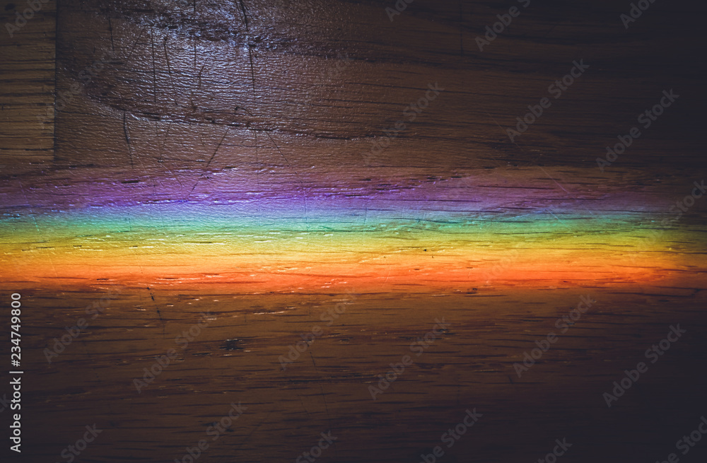 Obraz premium Close up macro photo of rainbow on wooden floor.