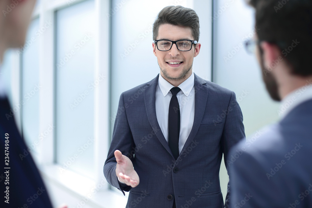 boss talking to employees standing in the office boss talking to employees standing in the office