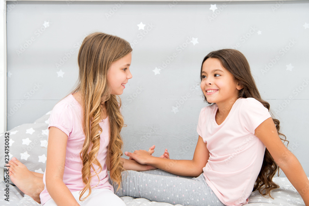 Girls having fun together. Girlish leisure. Sisters friends share gossips having fun at home. Pajamas party for kids. Siblings best friends. Sisters or best friends spend time together in bedroom Girls having fun together. Girlish leisure. Sisters friends share gossips having fun at home. Pajamas party for kids. Siblings best friends. Sisters or best friends spend time together in bedroom