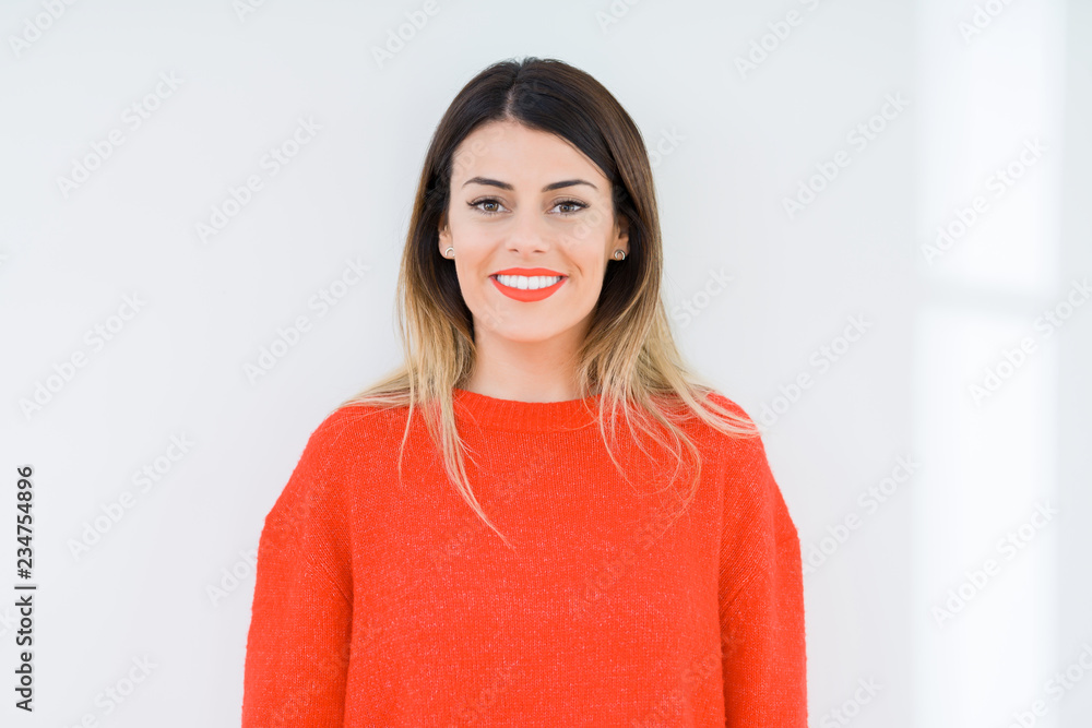 Young woman wearing casual red sweater over isolated background with a happy and cool smile on face. Lucky person. Young woman wearing casual red sweater over isolated background with a happy and cool smile on face. Lucky person.