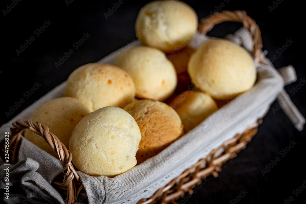 Brazilian homemade cheese bread, AKA 'pao de queijo' in a rustic basket. Brazilian homemade cheese bread, AKA 'pao de queijo' in a rustic basket.