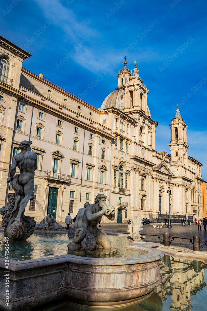 The Fontana del Moro, sculpted by Giacomo della Porta, in Piazza Navona, the ancient Stadium of Domitian, in Rome, Italy. Church of Sant'Agnese in Agone in the background.