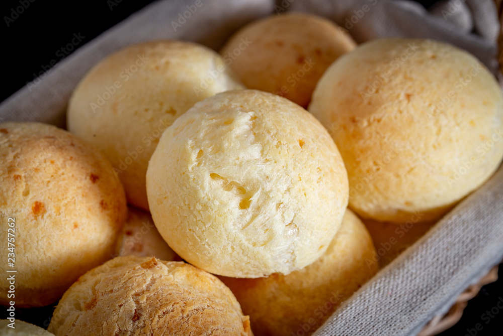 Brazilian homemade cheese bread, AKA 'pao de queijo' in a rustic basket. Brazilian homemade cheese bread, AKA 'pao de queijo' in a rustic basket.