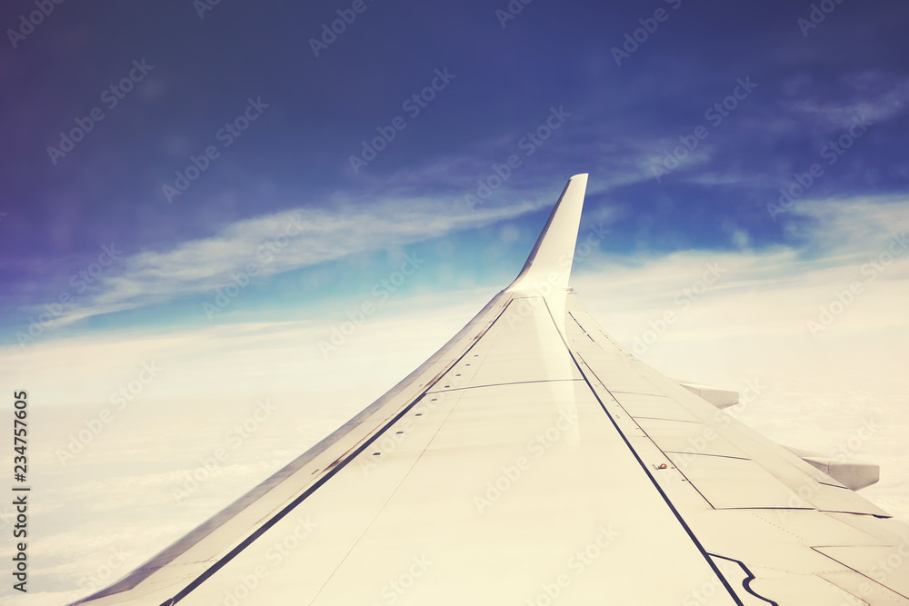 Color toned picture of an airplane wing, selective focus.