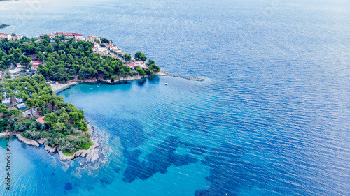Fototapeta Naklejka Na Ścianę i Meble -  Drone aerial view of sea shore on stones and blue water
