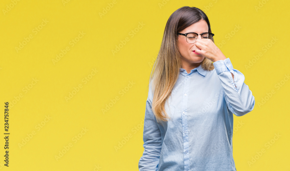 Young beautiful business woman wearing glasses over isolated background smelling something stinky and disgusting, intolerable smell, holding breath with fingers on nose. Bad smells concept. Young beautiful business woman wearing glasses over isolated background smelling something stinky and disgusting, intolerable smell, holding breath with fingers on nose. Bad smells concept.