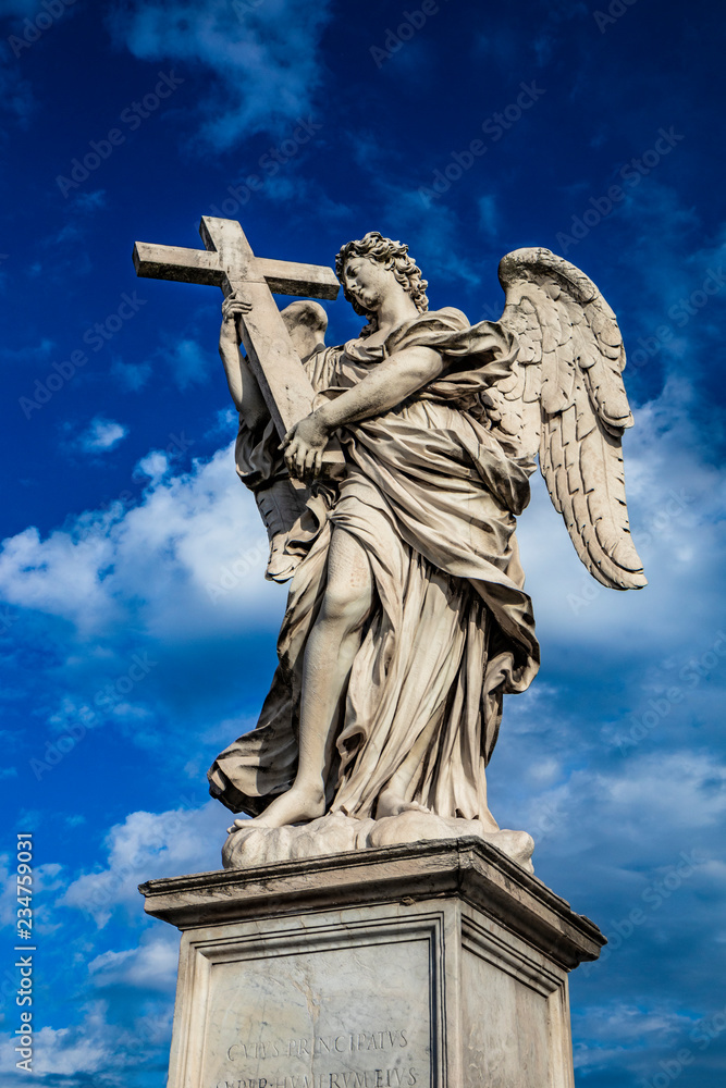 Angel with the cross on the Ponte Sant'Angelo over the Tiber, at the Mausoleum of Roman Emperor Hadrian, usually known as Castel Sant'Angelo, in Rome, near the Vatican. Italy
