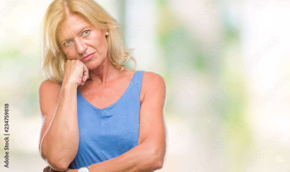 Middle age blonde woman over isolated background thinking looking tired and bored with depression problems with crossed arms. Middle age blonde woman over isolated background thinking looking tired and bored with depression problems with crossed arms.