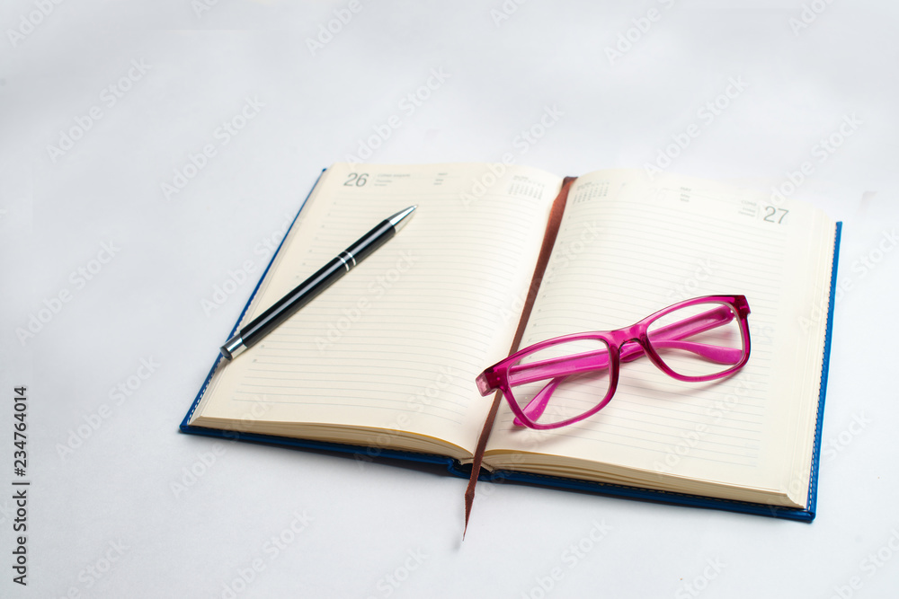 Fototapeta premium Notebook with glasses and pen, Book with glasses, Blue notebook with glasses, Book with cup of tea