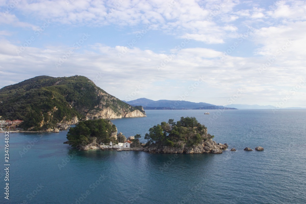 The small island of Panagia in Parga town in regional unit of Preveza in Epirus, Greece. Parga lies on the Ionian coast in Mediterranean sea The small island of Panagia in Parga town in regional unit of Preveza in Epirus, Greece. Parga lies on the Ionian coast in Mediterranean sea