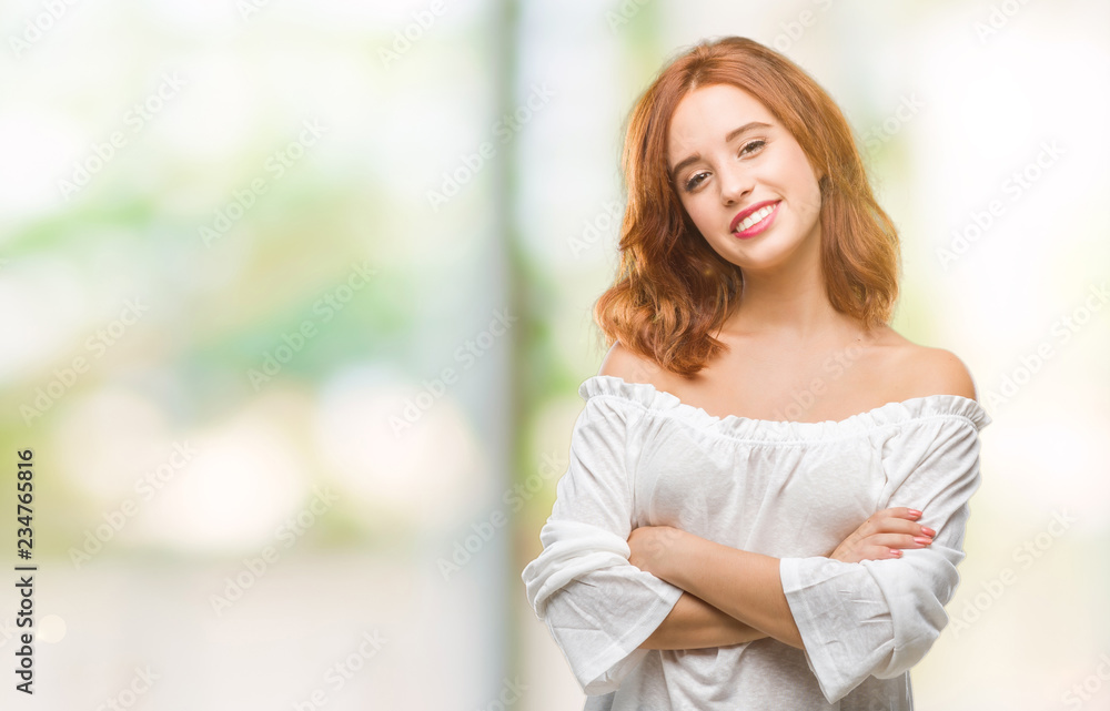 Young beautiful woman over isolated background happy face smiling with crossed arms looking at the camera. Positive person.