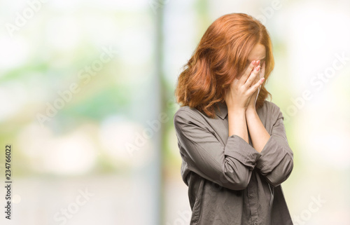 Young beautiful woman over isolated background with sad expression covering face with hands while crying. Depression concept. © Krakenimages.com