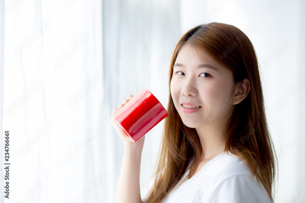 Beautiful of portrait young asian woman with drink acup of coffee standing curtain window background in bedroom, girl relax in morning at home, lifestyle concept. Beautiful of portrait young asian woman with drink acup of coffee standing curtain window background in bedroom, girl relax in morning at home, lifestyle concept.