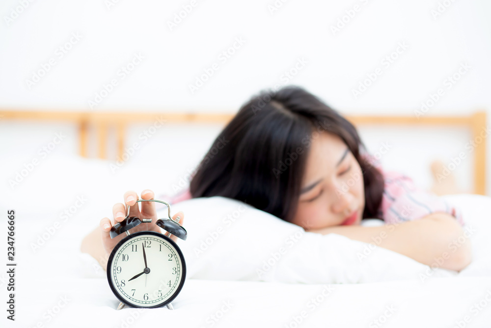 Beautiful asian young woman turn off alarm clock in morning, wake up for sleep with alarm clock, relax and lifestyle concept. Beautiful asian young woman turn off alarm clock in morning, wake up for sleep with alarm clock, relax and lifestyle concept.