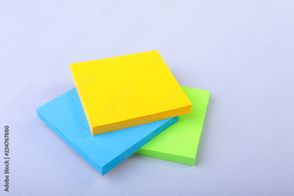 White notepad with colorful sticky reminder notes White notepad with colorful sticky reminder notes