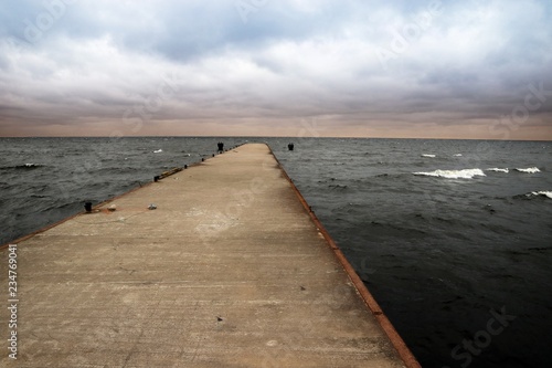 Pier going out into the Bay Cape Flotski under stormy skies. photo