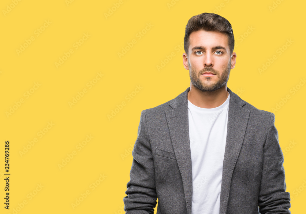 Young handsome business man over isolated background with serious expression on face. Simple and natural looking at the camera. Young handsome business man over isolated background with serious expression on face. Simple and natural looking at the camera.